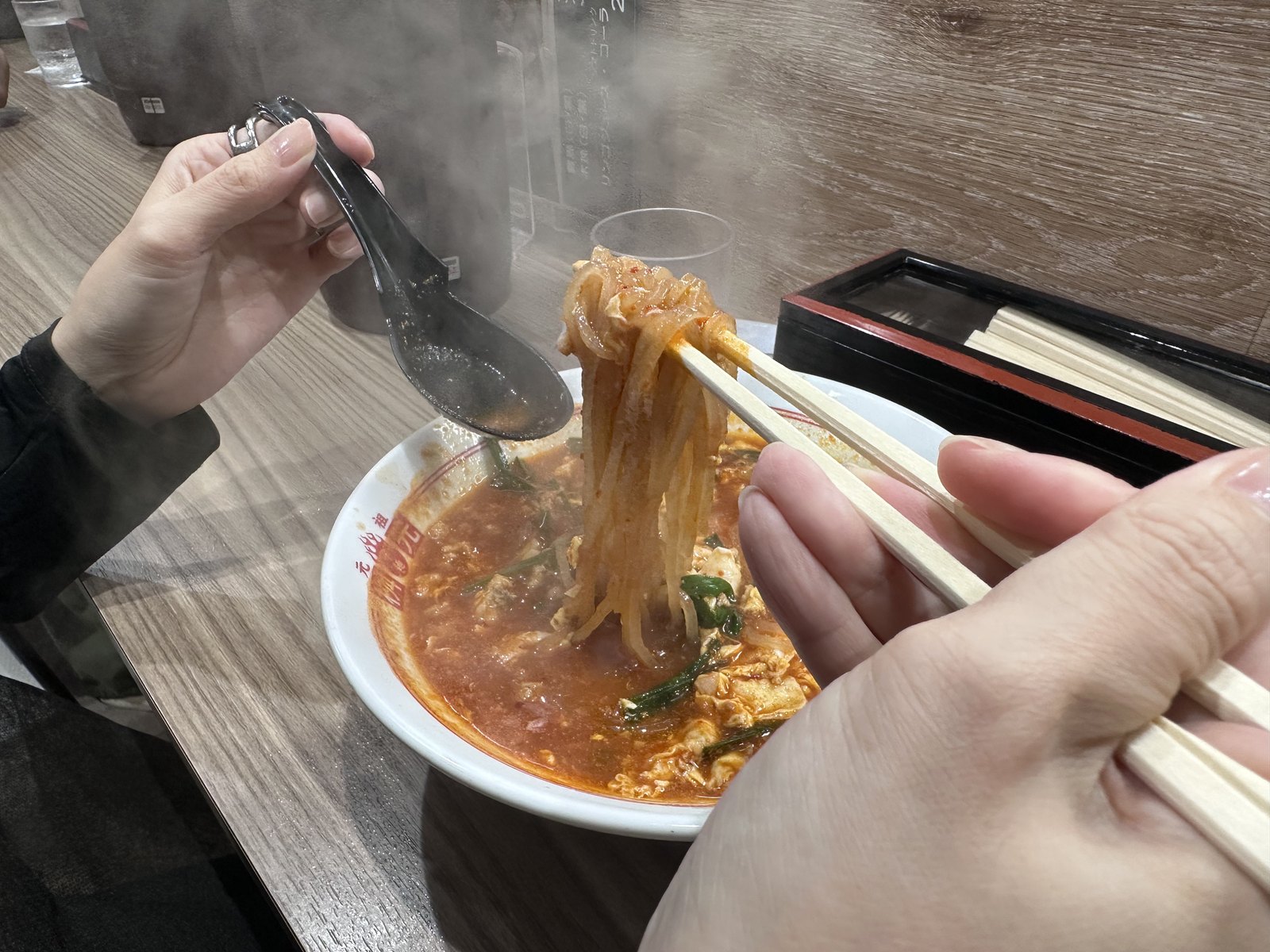 トマト辛麺の麺を持ち上げたところ